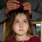 Bambina con pidocchi nei capelli
